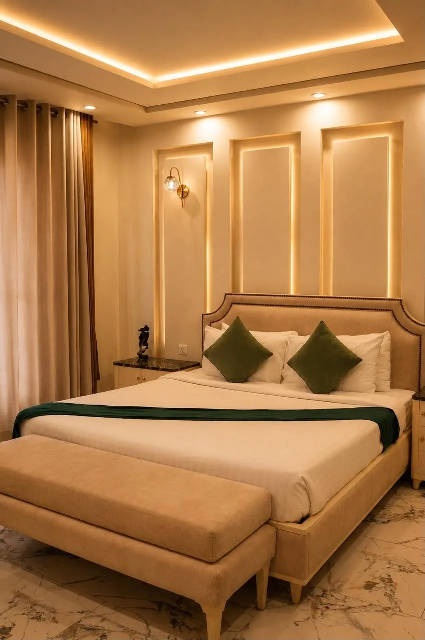 Executive Suite bedroom with backlit cream panelling and a marble floor